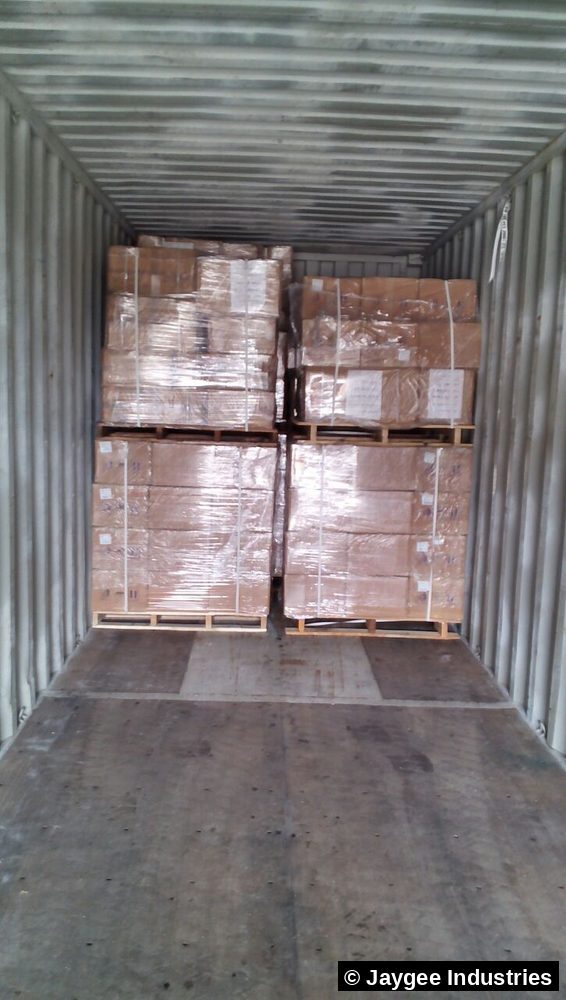 Four shrink-wrapped pallets of incense cartons neatly loaded inside a shipping container