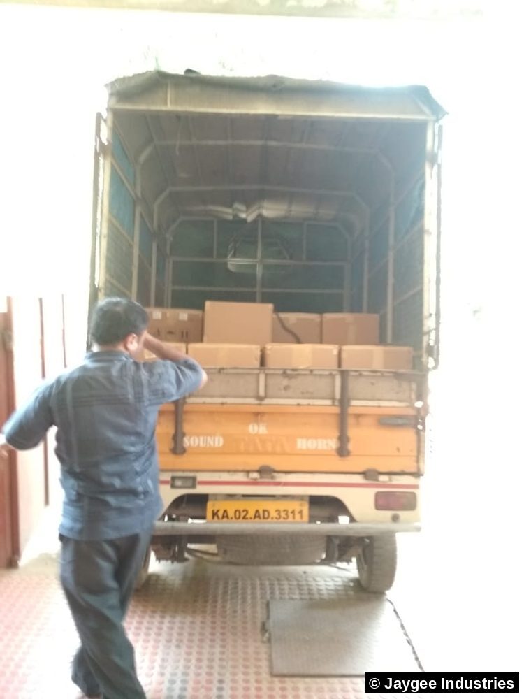 A Jaygee Industries team member loading boxes of incense onto a dispatch truck