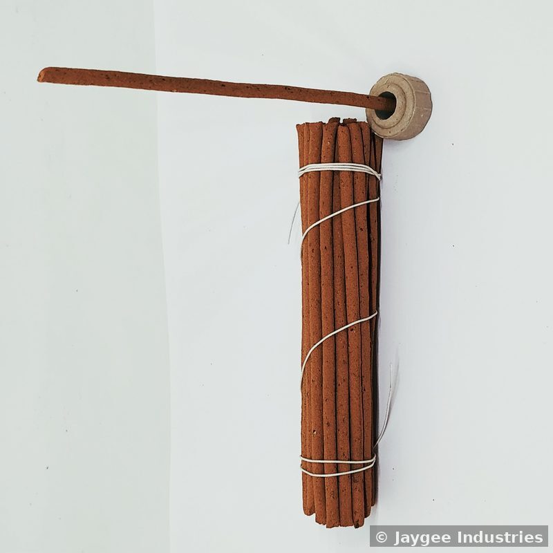 Bundle of raw Tibetan incense sticks tied together with a clay holder